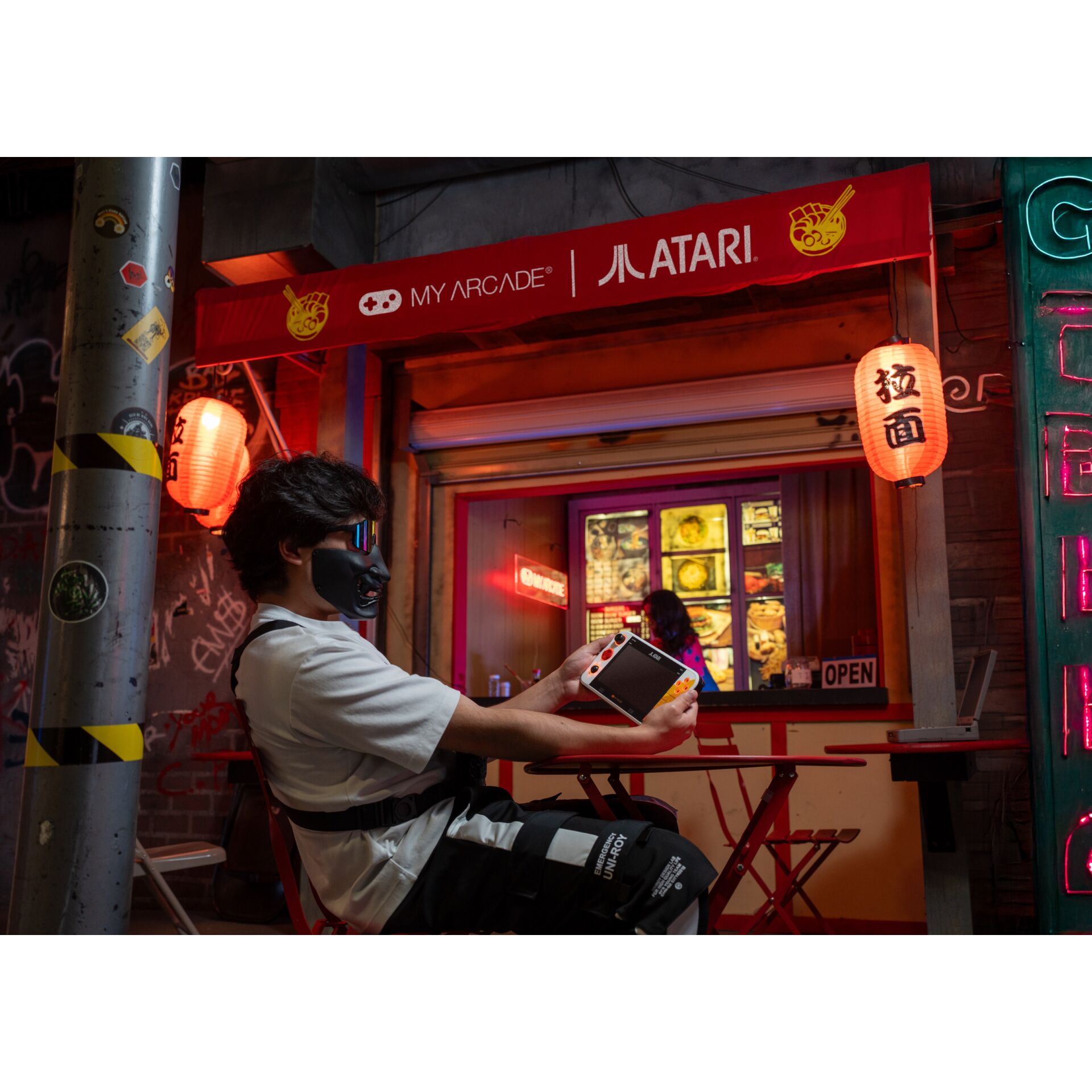 gaming-console, handheld, neon, asian-restaurant, outdoor-seat