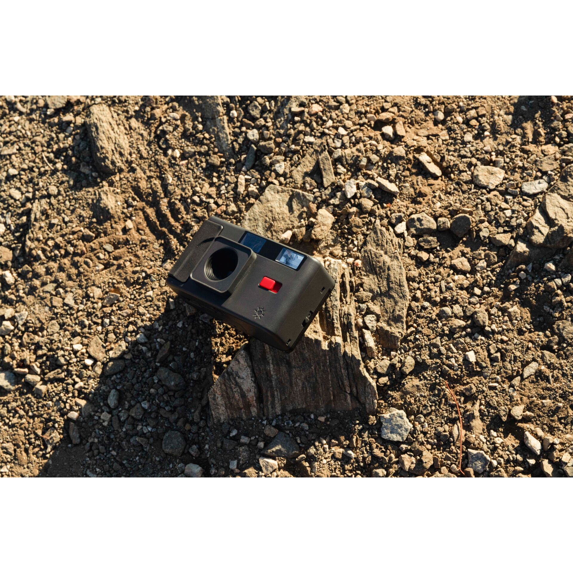 old-camera, film-camera, black camera, red button, muddy ground