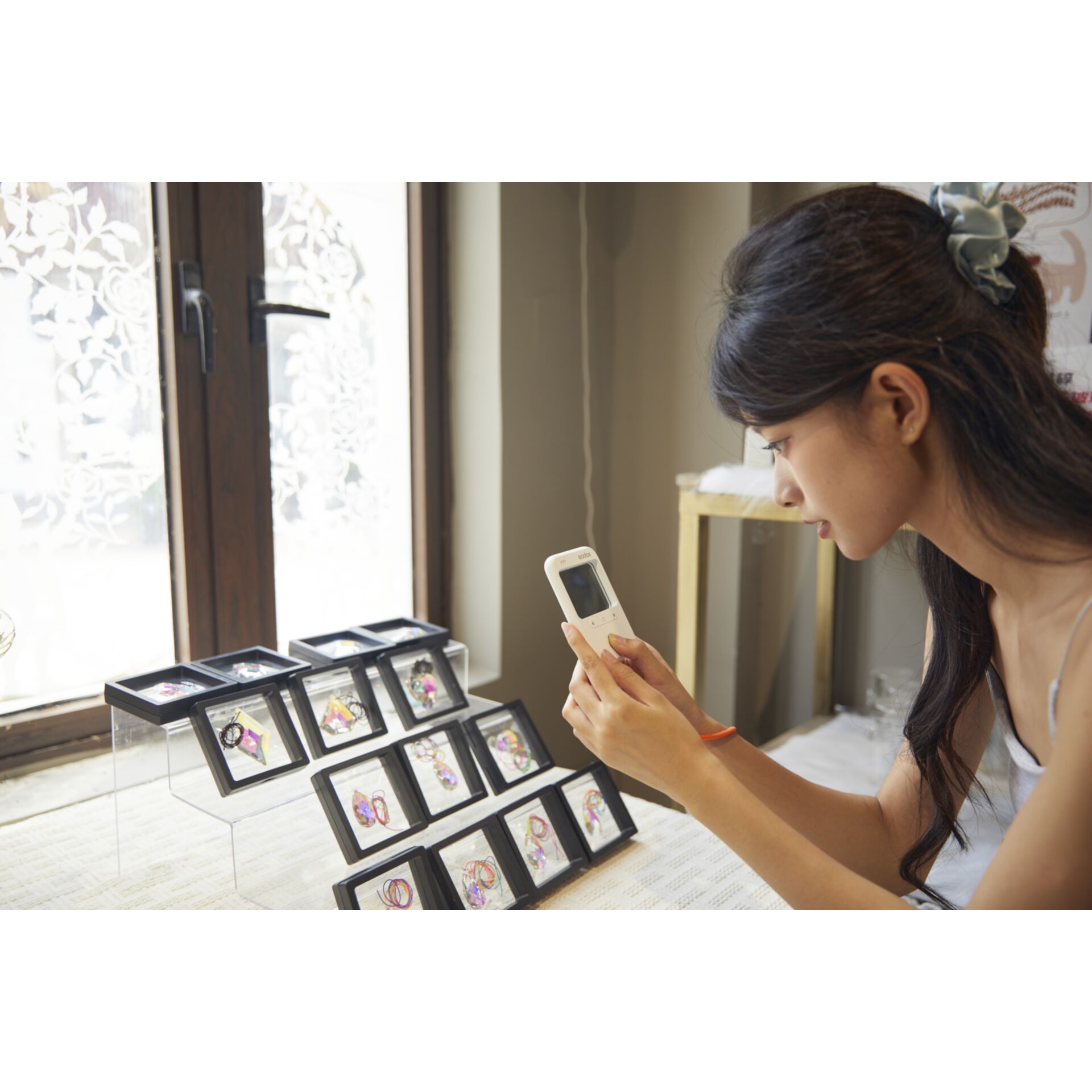 handheld device, searching phone, jewelry display, earrings, woman shopping
